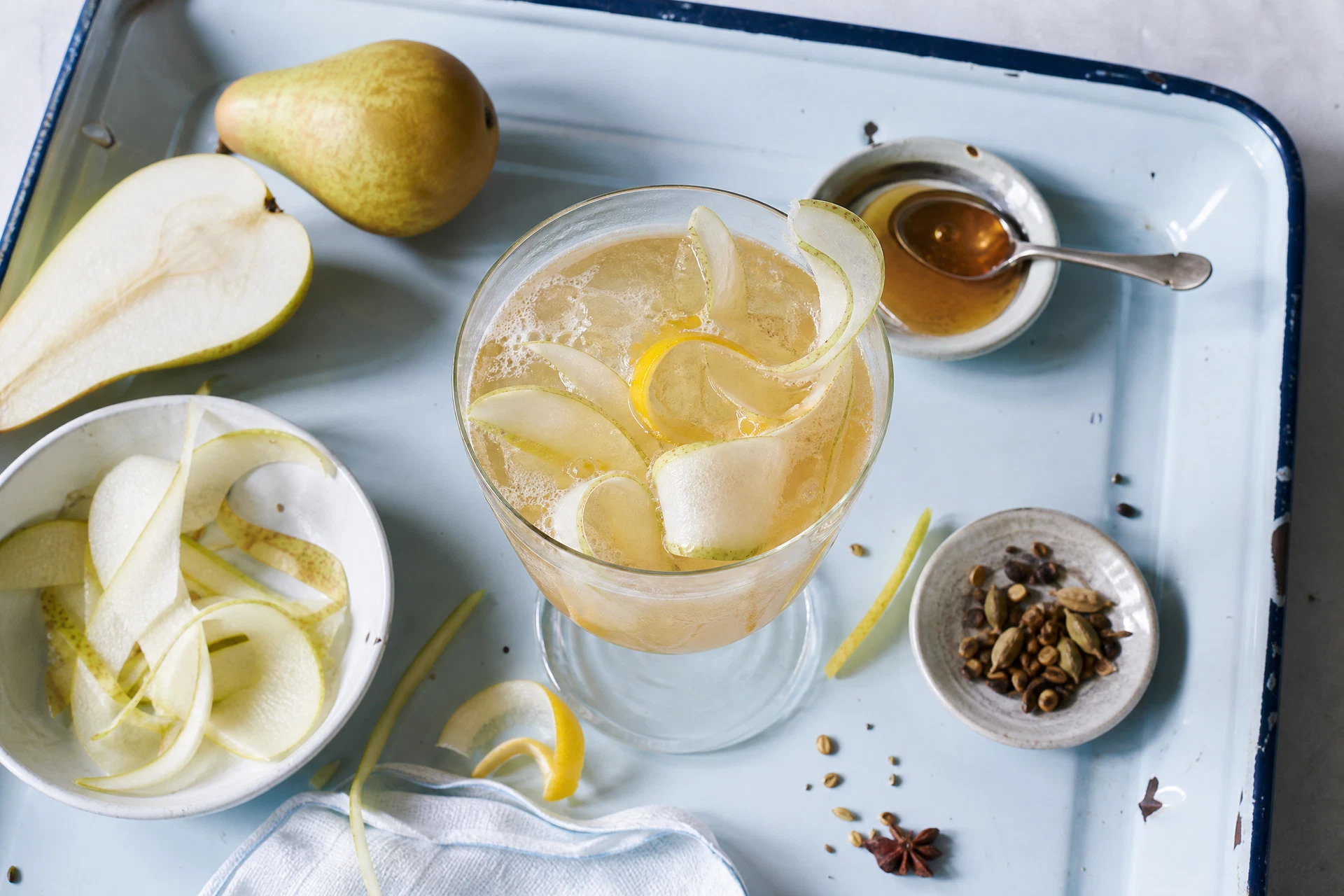 Close-up of a sparkling mocktail garnished with dried chamomile flowers.