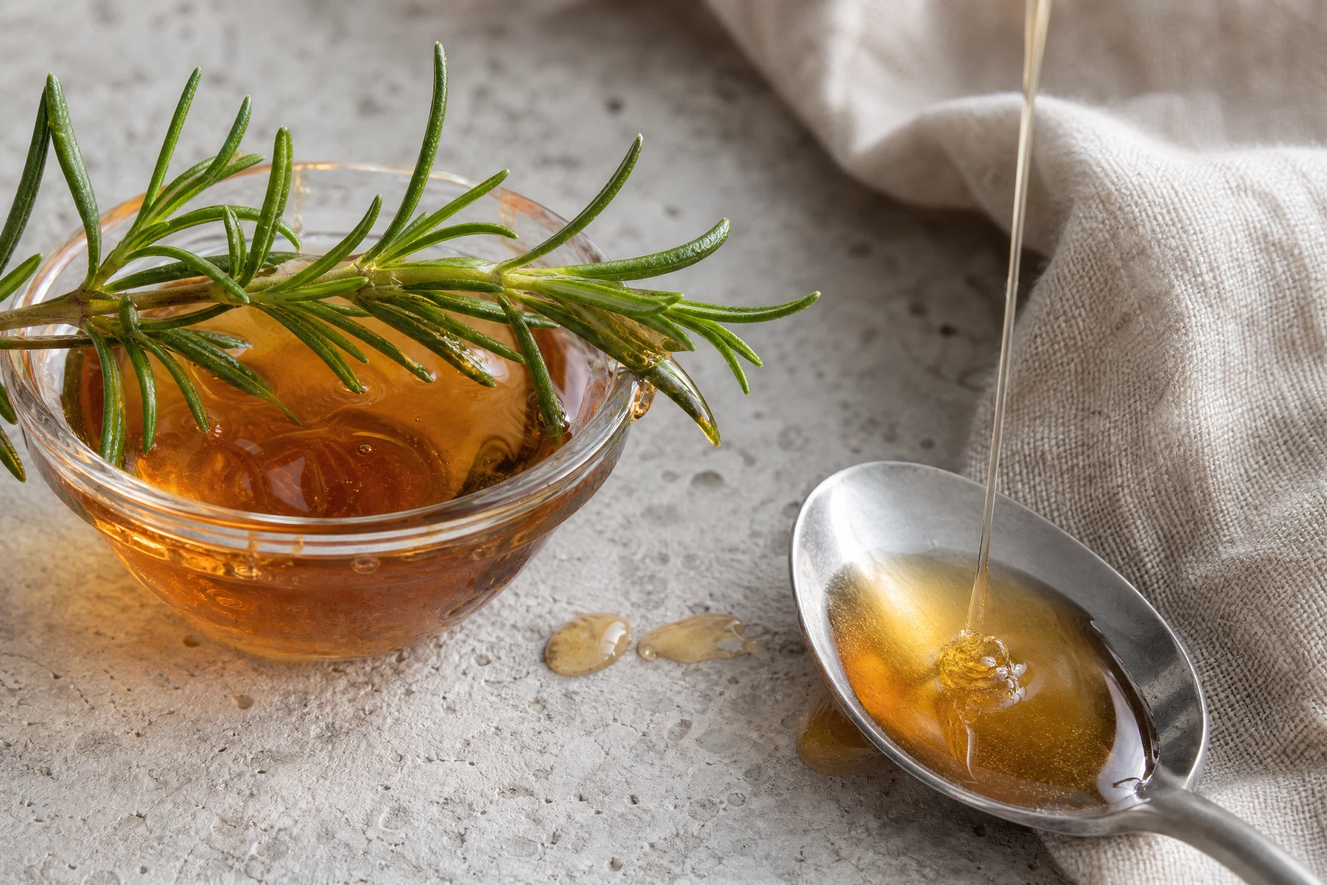 Rosemary-infused maple syrup being poured into a cocktail shaker with cranberry juice.