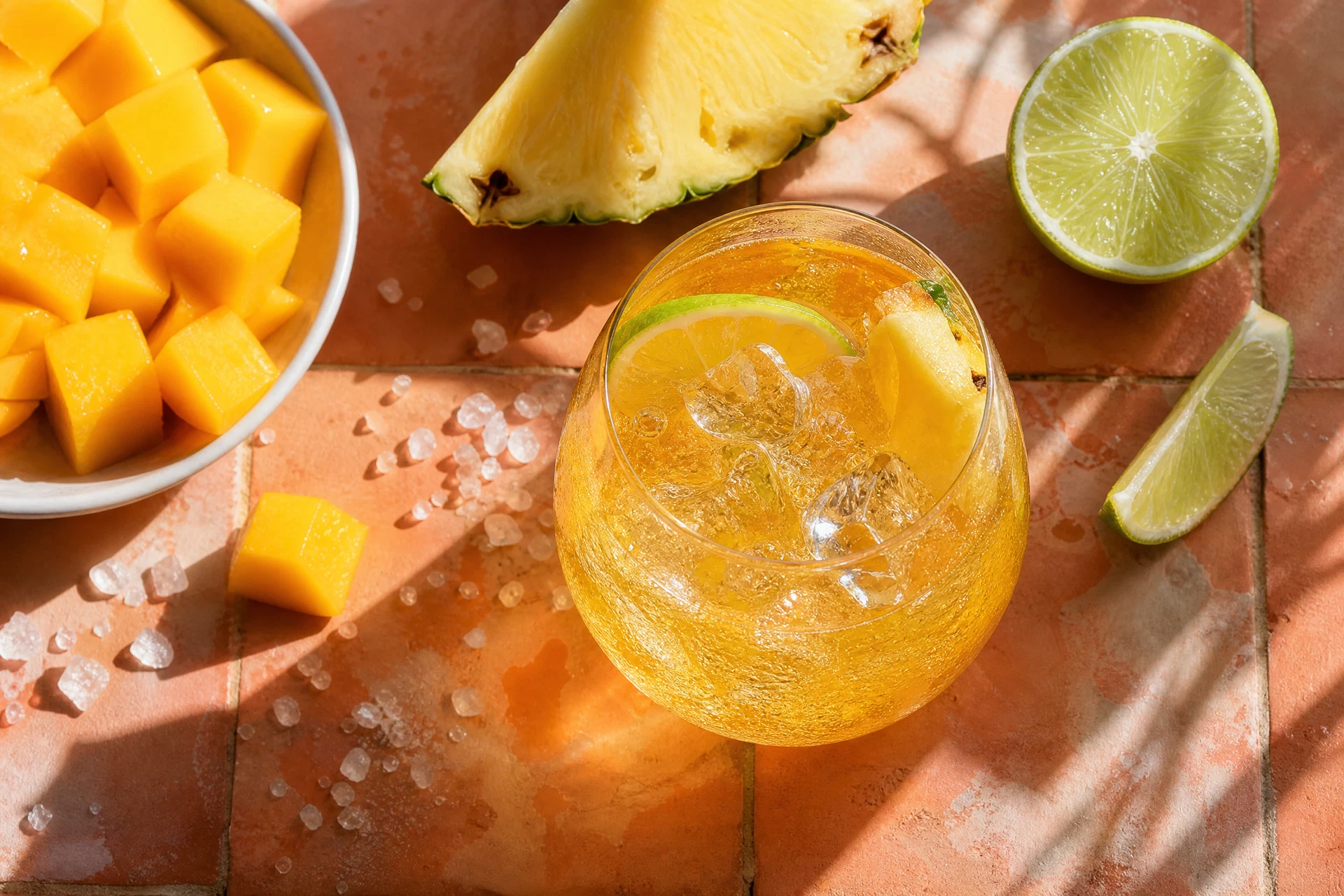 Close-up of a toasted coconut rim on a refreshing tropical beverage against a sunset background.