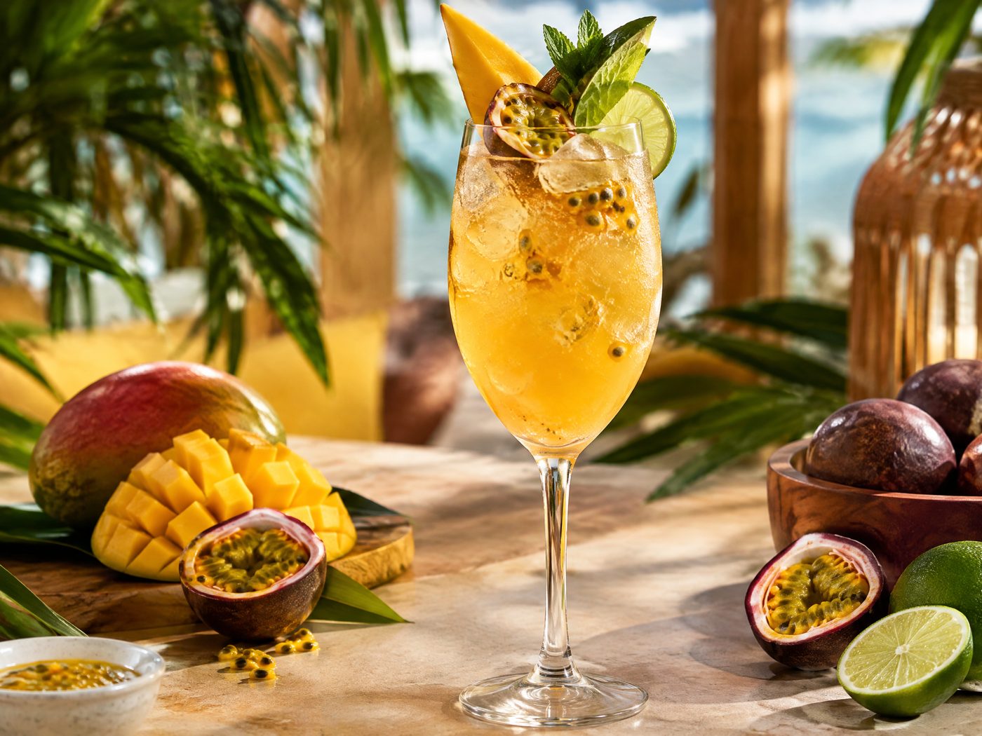 Mango Passion Fruit Spritz mocktail with mango, passion fruit, citrus, and sparkling golden bubbles