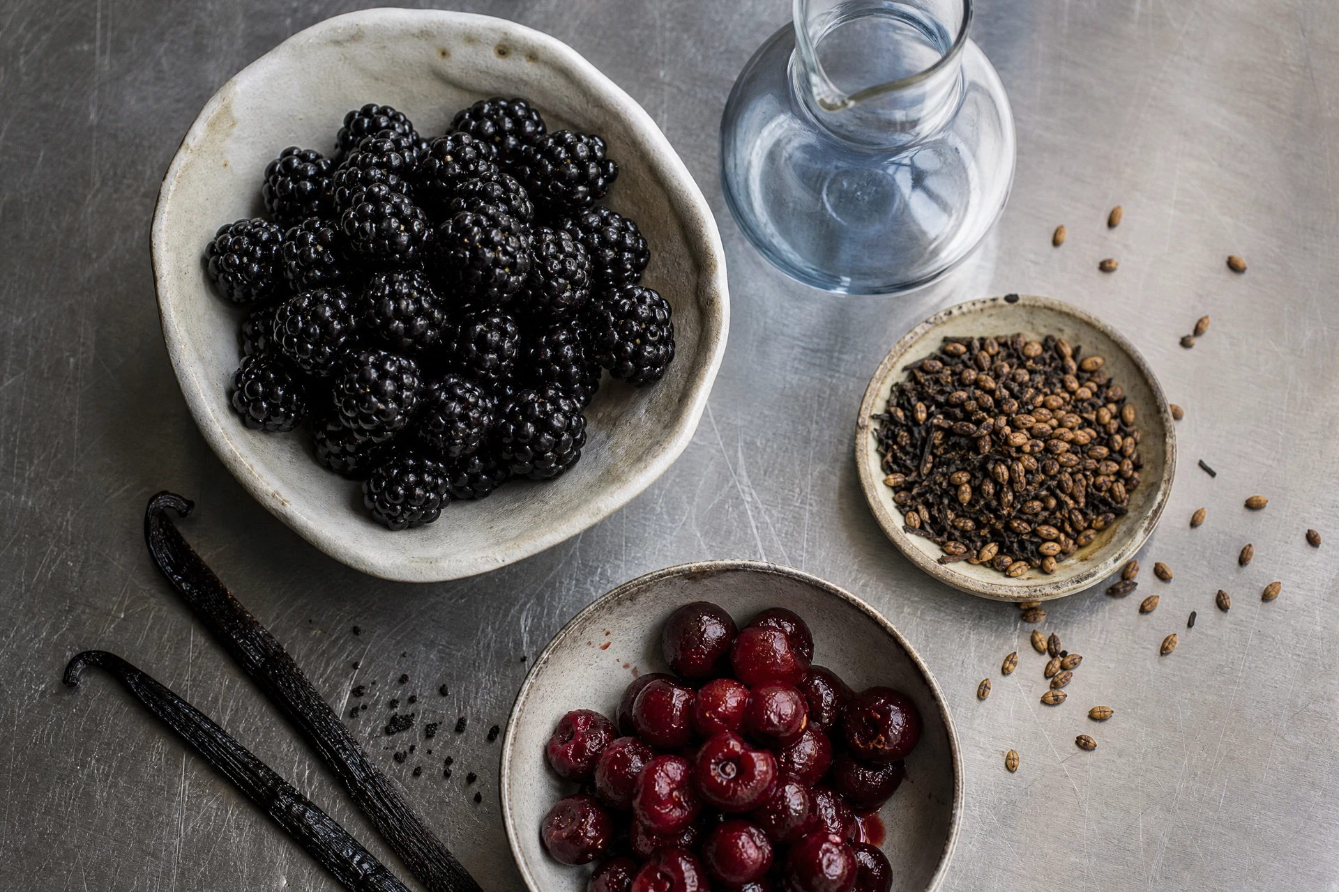 Muddled blackberries and vanilla syrup being prepared for a mocktail.